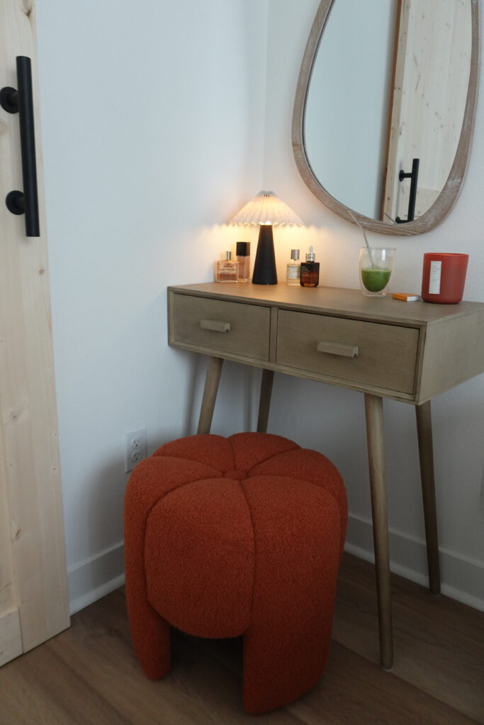 makeup vanity console table with burnt orange pumpkin stool small bedroom