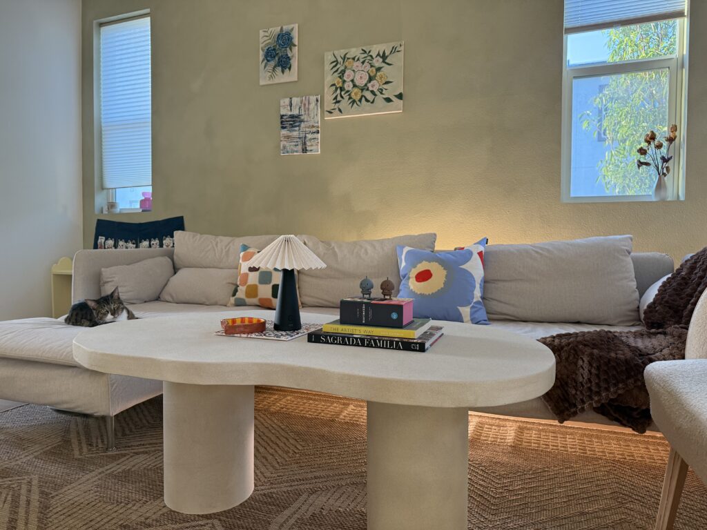 living room with travel souvenir coffee table decor styled with Spanish tile coasters, Nordic lamp and coffee table books