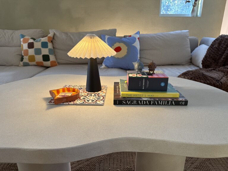 travel souvenir coffee table decor styled with Spanish tile coasters, Nordic lamp and coffee table books